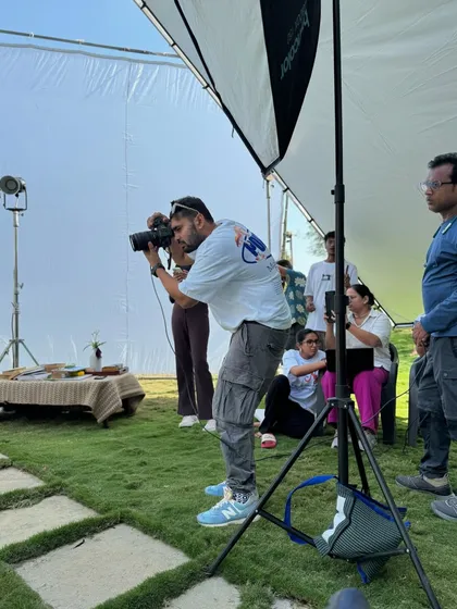 Here I am in my element, directing an outdoor lifestyle shoot. My process is hands-on and collaborative, ensuring every detail from lighting with diffusers to composition is perfect, even when working in a dynamic, natural environment.