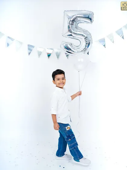 Another great shot with the balloon, capturing a happy and proud moment for the birthday boy.