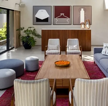 A different perspective of the living space, showing how we use furniture and art to define areas within an open-plan layout. The clean lines of the console and the modern art triptych add a layer of curated sophistication.