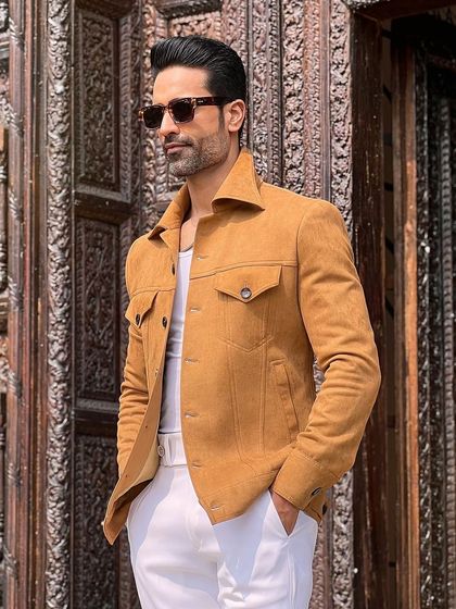 A closer look at the rich texture of the camel-colored suede and the jacket's classic four-pocket design.