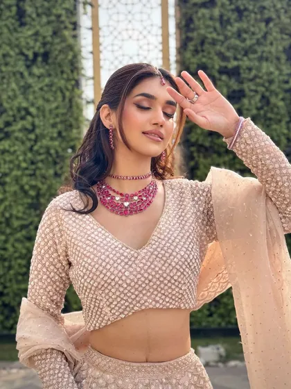 A playful and candid moment captured beautifully. The makeup stays flawless, allowing the bride to be herself and enjoy her special day without any worries.