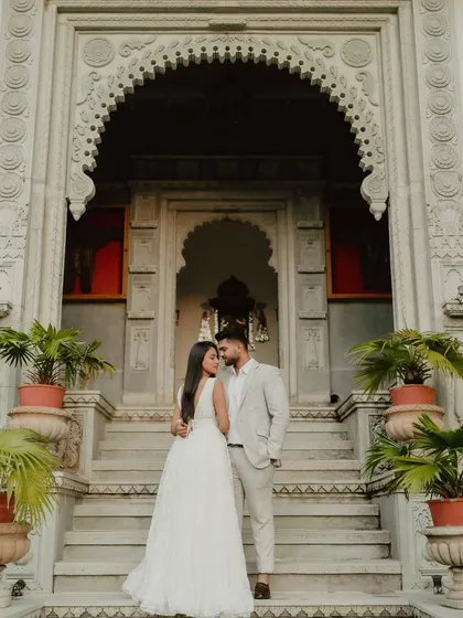 A majestic portrait in front of a heritage property. For destination weddings in places like Jaipur, we use the stunning architecture as a backdrop for regal photos.