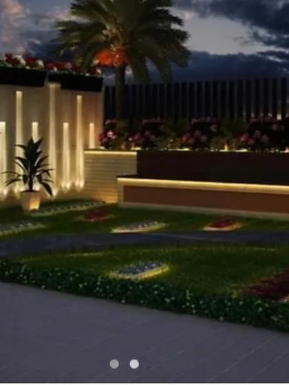 A modern backyard design featuring a raised wooden bench with under-lighting and a beautiful flower bed. The design uses clean lines and a combination of hardscape and softscape for a contemporary look.