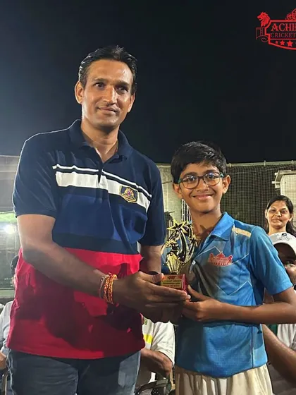 A player receiving his award at the AT Sports U-11 Night Tournament ceremony.