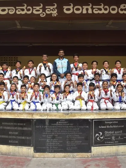 A group photograph with all the participants and medal winners from our academy. Seeing this large group of disciplined students together is a great source of pride.