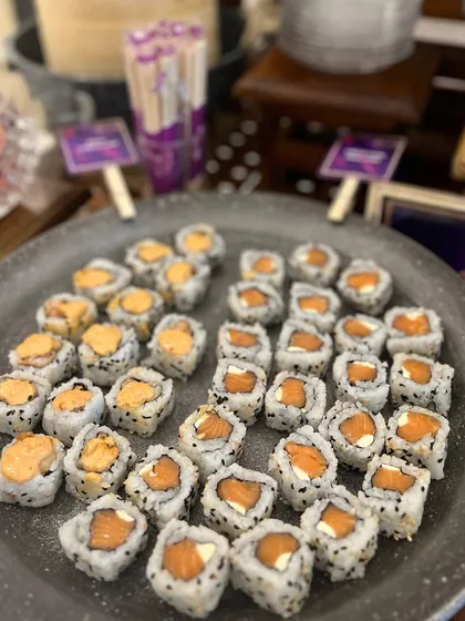 A platter of assorted sushi rolls ready for an event. I offer a variety of fillings and toppings to cater to different tastes, including vegetarian and non-vegetarian options.