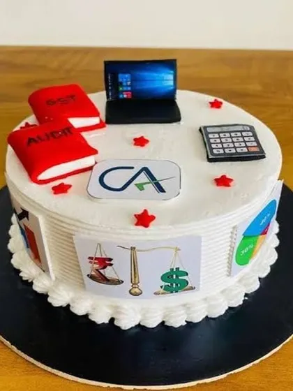Marking the incredible achievement of becoming a Chartered Accountant. This cake is decorated with edible toppers representing the profession, including a laptop, calculator, and books for Audit and GST. The sides feature symbols of finance and justice, making it a truly customized tribute.