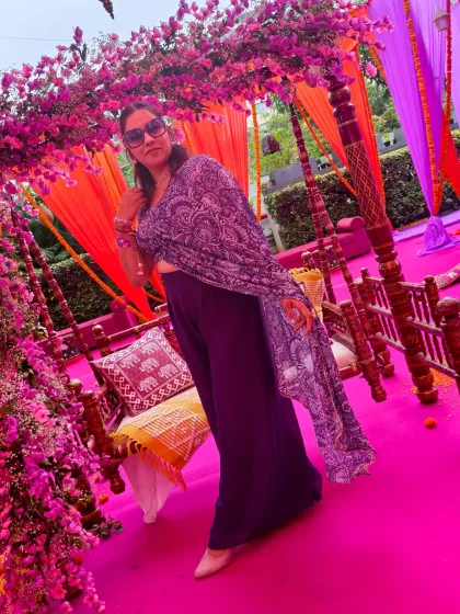 Posing amidst the stunning floral decor of a Mehendi ceremony. The vibrant colors and festive feel are the perfect backdrop for a high-energy event.