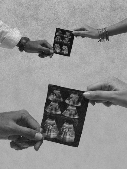 A symbolic black and white shot of the parents' hands exchanging the sonogram. This artistic photo represents the shared journey and the gift of new life they are creating together.