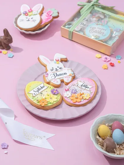 A plate of personalized Easter cookies with names written in beautiful script, ready for gifting.