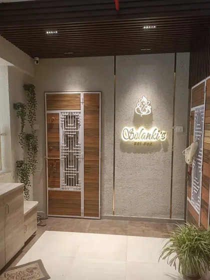 This is a complete lobby design I created for a client. It includes a custom safety door, a backlit nameplate, textured walls, and a seating area with shoe storage underneath.