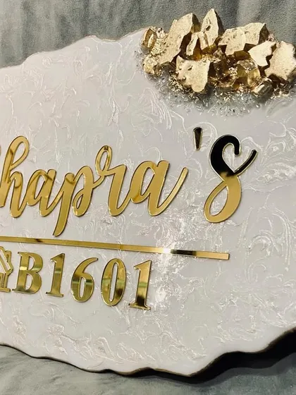 This video showcases a custom house nameplate I created for a client. The elegant white marble resin is accented with gold flakes and features the family name and house number in a beautiful golden script.