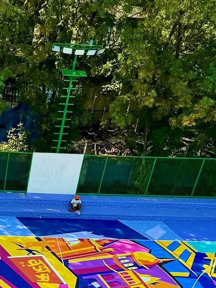 A moment of perspective during the NBA 2K court painting. From this angle, you can appreciate the scale of the figures and the precision required to execute such a large-scale design.