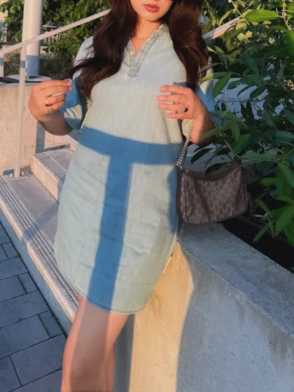 A close-up detail shot of the Calvin Klein dress in golden hour lighting.