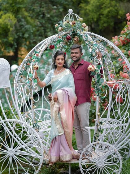 A couple poses in the fairytale Cinderella carriage, a perfect spot for a romantic photo.