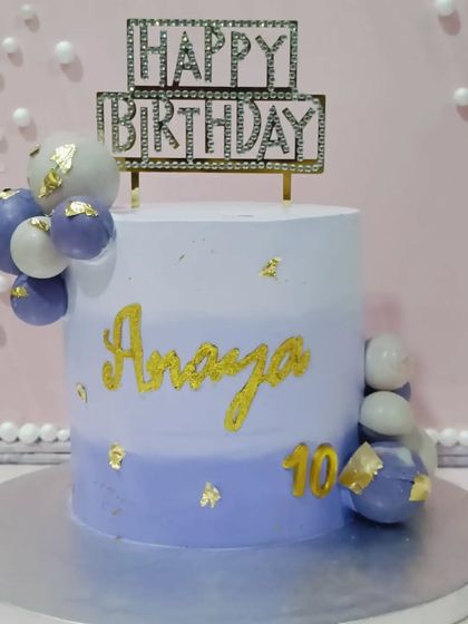 A lovely lavender-hued cake for a 10th birthday. The ombre effect and cascade of chocolate spheres create a modern and pretty design.