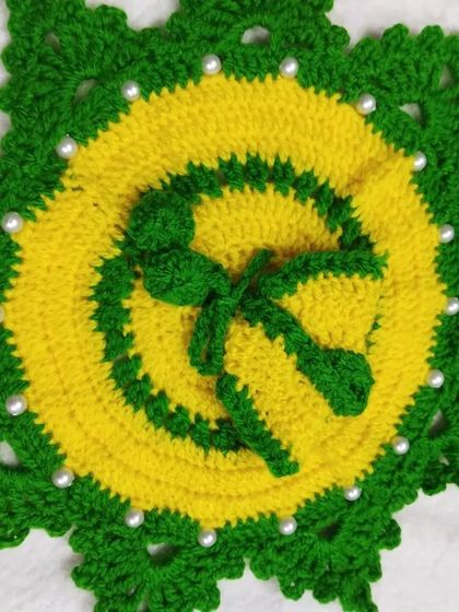 A star-shaped poshak in yellow and green, decorated with white pearls. This is a unique design that is both festive and warm for the winter months.