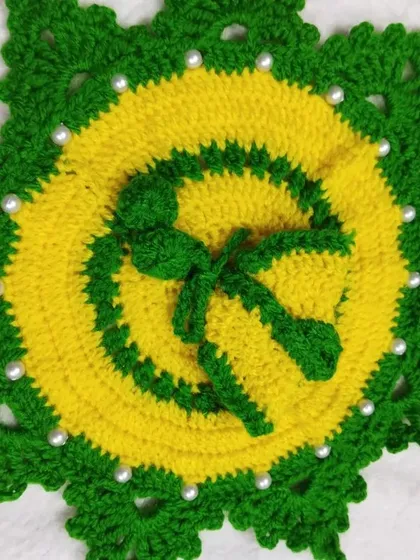 A star-shaped poshak in yellow and green, decorated with white pearls. This is a unique design that is both festive and warm for the winter months.