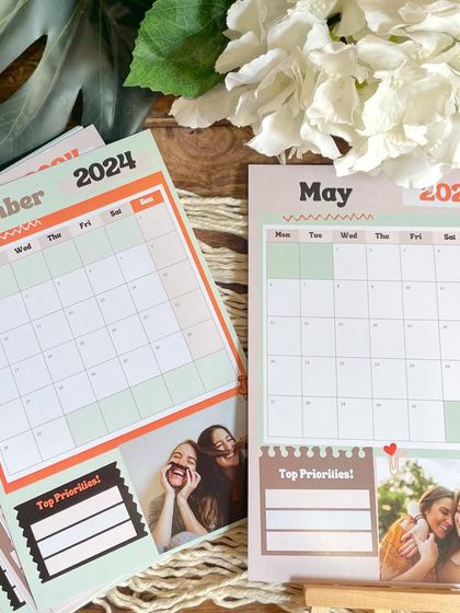 A side-by-side comparison of different monthly pages from the planner calendar, showcasing the customizable photo slots.