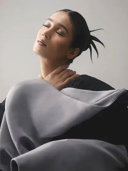 The dramatic pose and architectural clothing are perfectly balanced by the simple yet powerful white liner.