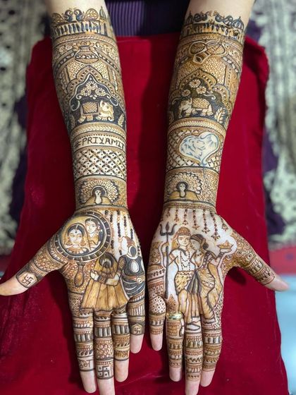 For a divine touch, I can create portraits of deities like Shiva and Parvati, as seen here alongside portraits of the bride's parents. The groom's name is also written on the arm.