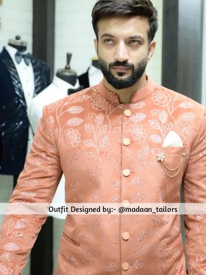 Another angle of the peach Jodhpuri blazer, showcased in our store. The mannequins in the background give a glimpse of our other tuxedo styles.