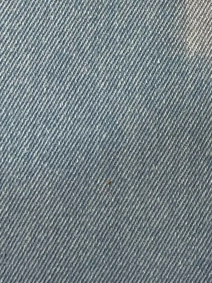 A light blue, rigid denim fabric. This material will soften with wear and mold to your body, creating a truly personalized fit.