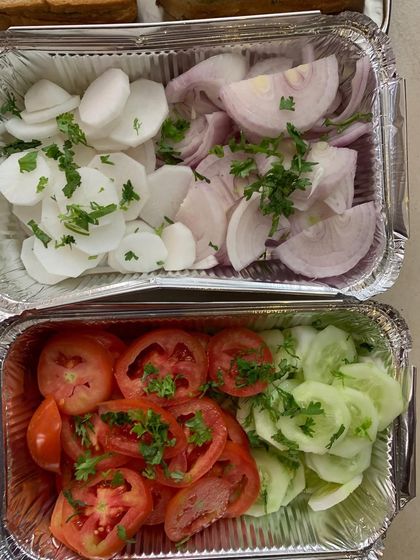 A simple salad of sliced tomatoes, cucumbers, onions, and radish.