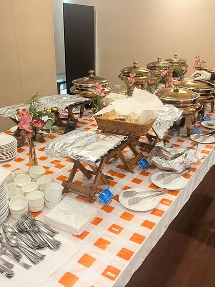 The buffet setup for the Dussehra lunch at Kotak Mahindra Bank, featuring our signature checkered tablecloths and elegant chafing dishes, ready to serve hundreds of employees.