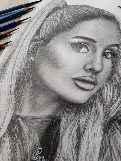 A close-up of the Ariana Grande drawing, showing the fine details in her hair and the smooth blending on her skin.