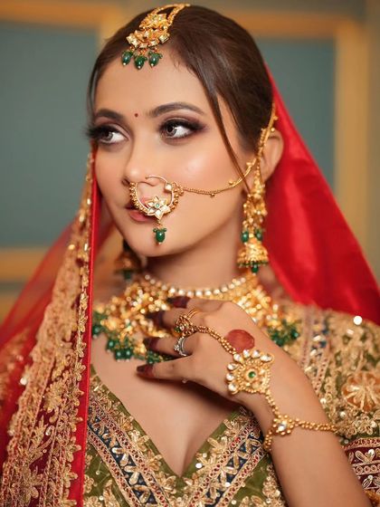 A side profile shot, showing off the intricate details of her nath and the flawless makeup application.