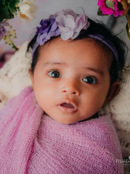 Those big, beautiful eyes are just mesmerizing. A simple swaddle and a floral background are all you need to create a stunning portrait.