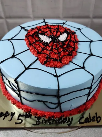 A Spider-Man face cake for Caleb's 5th birthday. I used buttercream piping to create the iconic mask and web design.