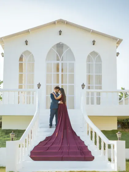 This special setup with a pristine white facade offers a touch of European elegance right here in Jaipur. The bride's deep purple gown with its long train creates a stunning visual on the grand staircase.
