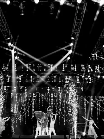 A black and white shot capturing the drama and scale of a couple's lift. Surrounded by backup dancers and cold pyros, this moment was choreographed to be a showstopper.