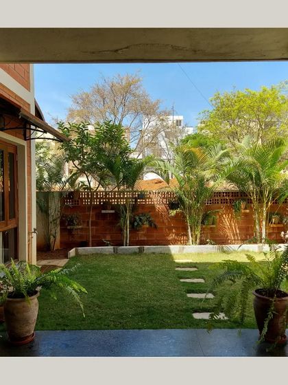 A view from inside the house, looking out onto a green lawn, perfectly framed by the doorway.