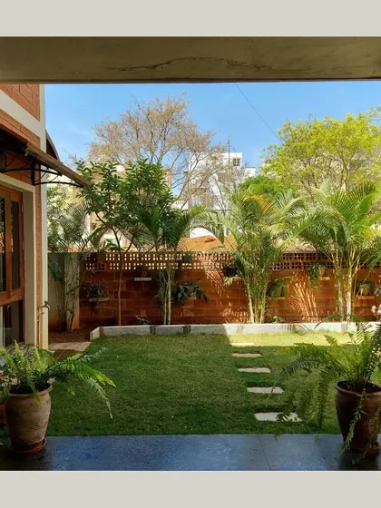 A view from inside the house, looking out onto a green lawn, perfectly framed by the doorway.