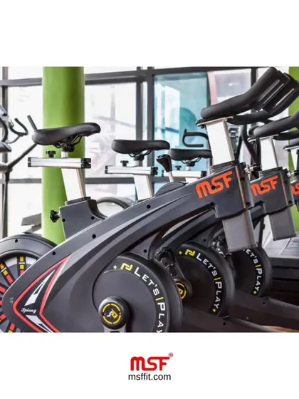 A close-up of our durable and sleek MSF spin bikes. They feature adjustable resistance and ergonomic design, making them a favorite in the gyms we set up.