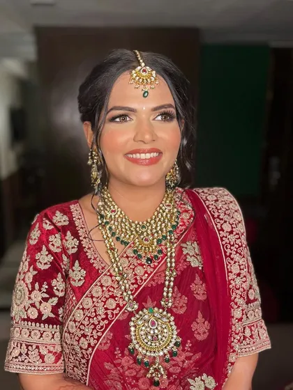 Nutisha's smile says it all. I created her dream wedding look with a focus on warm tones and a radiant finish to match her vibrant red lehenga.