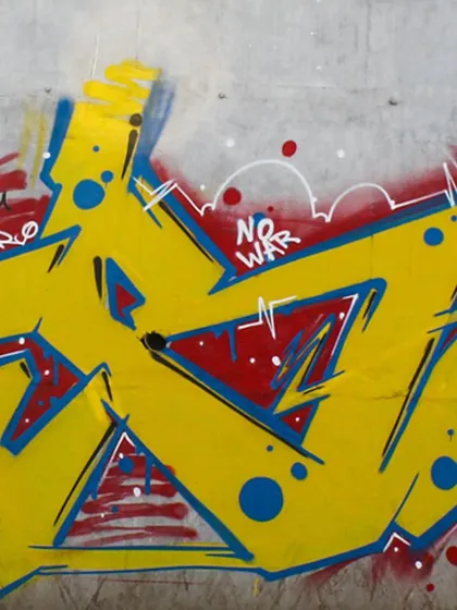 A close-up of the wildstyle lettering from the "No War" mural, showing the sharp angles and clean lines.