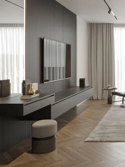 This bedroom features a dark, fluted accent wall that houses the TV and a floating vanity. The dark wood floor and modern furniture create a chic, contemporary look.