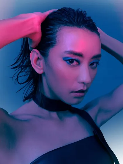 A beauty-focused shot from the neon series, capturing a moment of quiet intensity. The wet-look hair and the colored lighting work together to create a sleek, modern portrait.