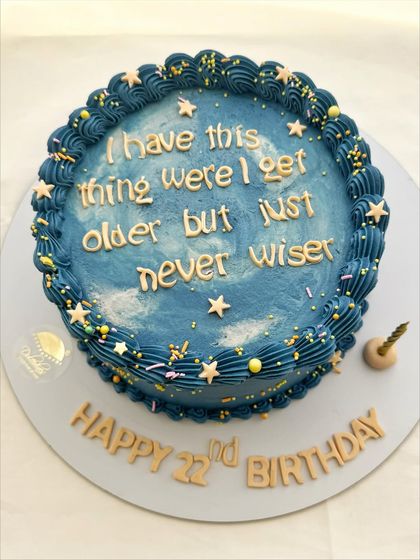 A fun galaxy-themed cake with the quote "I have this thing where I get older but never wiser."