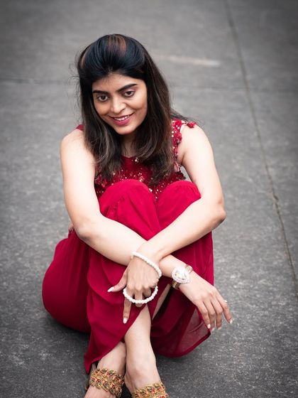 A smiling, seated portrait taken outdoors. This relaxed pose is great for creating a friendly and approachable image.