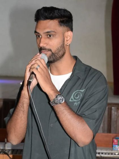 Percy taking the mic to announce results and give feedback at the St. Anne's competition. We make it a point to connect directly with the dancers, offering words of encouragement and expert advice to help them grow.