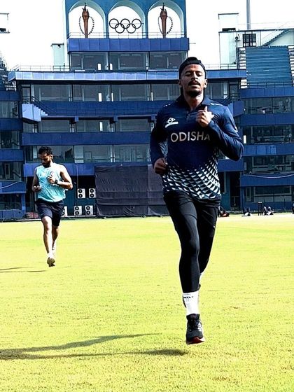 An athlete running on the field at the stadium. There is no substitute for practicing speed in the environment where it matters most.