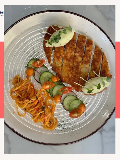 For something a little different, try our crispy crumbed chicken. It's served with a side of vegetable spaghetti and a light salad, offering a balanced and delicious plate that's both comforting and refined.