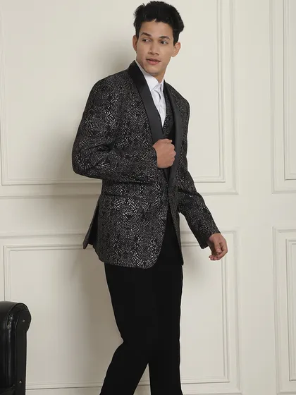 A model showcases the black and silver patterned tuxedo, a great choice for a formal event where you want to stand out.