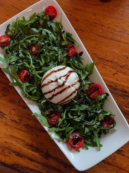 Creamy burrata and fresh greens, drizzled with balsamic. This salad is just what you need on a warm, sunny day.