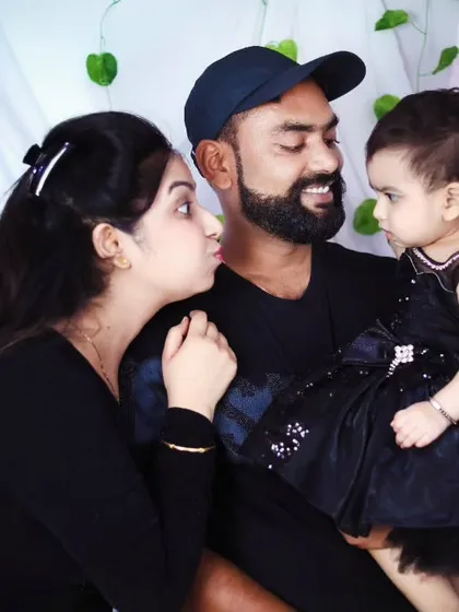 A sweet family moment, with the mother about to give her daughter a kiss.